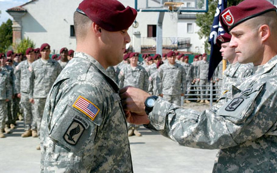 Staff Sgt. Christopher Upp receives the Silver Star from Lt. Col. Bill Ostlund, commander of the 2nd Battalion, 503rd Infantry Regiment, during a ceremony Wednesday on Caserma Ederle. Upp received the honor for his actions on July 31, 2007, at Vehicle Patrol Base Seray in Afghanistan.