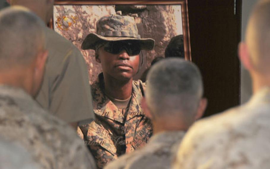 Marines pause after a memorial Wednesday at the Camp Hansen Chapel to honor Capt. Jesse Melton III, 29, with 12th Marines, 3rd Marine Division, who was killed Sept. 9 in Afghanistan
