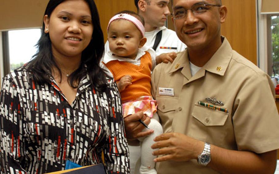 Chief Petty Officer Vic Hermano became a naturalized U.S. citizen in 1985. His wife, Alma, became an American on Friday, during a ceremony at Yokosuka Naval Base, Japan, thanks to a new law that allows military spouses to be naturalized overseas. The Hermanos are natives of the Philippines; Tiffany is their daughter.