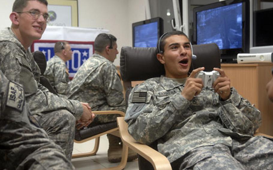 Pfc. Reimaldo Barrera, right, plays "Call of Duty 5" against players with the NFL’s Tampa Bay Buccaneers and fellow troops stationed around the world as part of a USO/Pros vs. GI Joe gaming competition on Veterans Day. The soldiers are outpatients at Landstuhl Regional Medical Center and were playing at the newly opened USO Warrior Center on Landstuhl.
