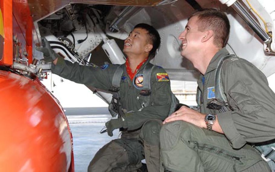 South Korean air force Lt. Col. Jeong Geun-hwa, left, and Navy Lt. Joshua Filbey examine the T-50 training aircraft at a South Korea base in Sancheon recently. FIlbey and three other flyers from the U.S. Naval Test Pilot School flew the advanced jet trainer this past week. The aircraft is considered a modern stepping stone to current and future jet fighters. Filbey and Marine Maj. Jonathan Ohman are writing technical reports on the aircraft as part of their graduation from the test pilot school.