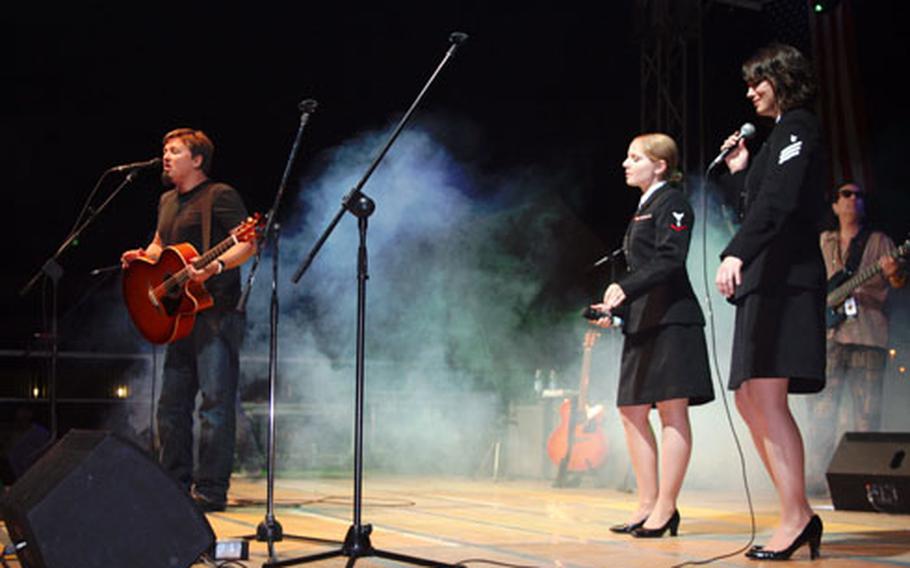 This winning picture features singer Edwin McCain and two Navy musicians performing in Naples, Italy. Condon, a social worker and mental health therapist stationed at Naval Hospital Naples, was one of six winners in the Armed Forces Entertainment Photo Contest.