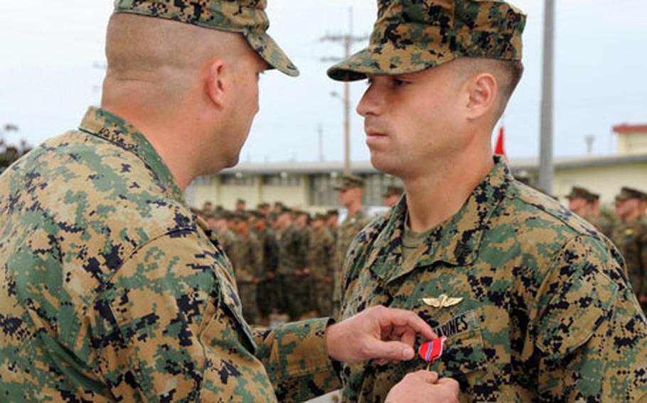 3rd Reconnaissance Battalion commander Lt. Col. Oliver B. Spencer, left, pins a Bronze Star with "V" on the chest of 3rd Recon’s Sgt. George J. Callum, 23, from Atlanta, during a Wednesday ceremony at Camp Schwab, Okinawa.