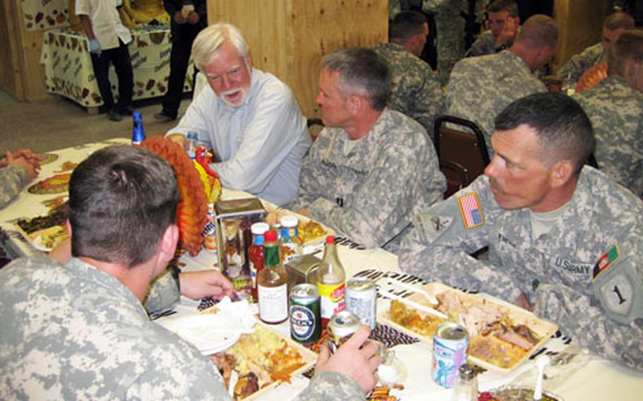 Undersecretary of the Army Nelson Ford, left, eats a Thanksgiving meal with soldiers with an Afghan Army Embedded Training Team working out of Gardez in eastern Afghanistan.