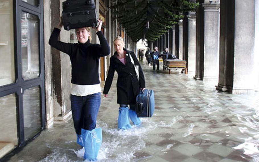 Tourists carry their luggage as they make their way through high water in Venice, Italy, on Monday. It’s the worst flooding in Venice in more than 20 years.