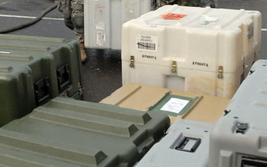 From left: Pfc. Ramzi Chebbi, Capt. Bruce Chojnacki, Pfc. Daniel McCurdy and Pvt. Nick Philips, all with Headquarters and Headquarters Company, 21st Theater Sustainment Command, unload equipment.