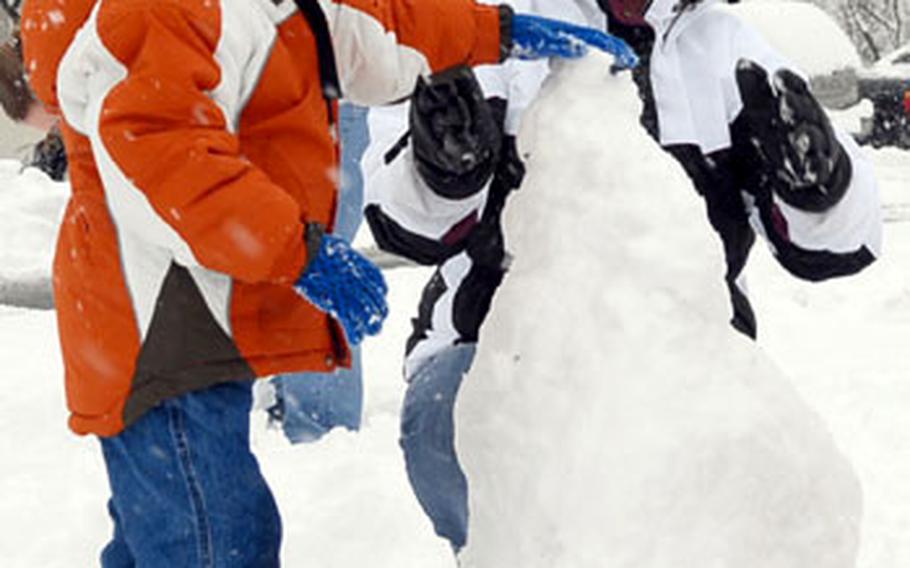 Christopher Wilson and his mom, Amber, build a snowman in Baumholder’s Wetzel housing area. After living in Texas and Oklahoma, she said that it was their first snowman.
