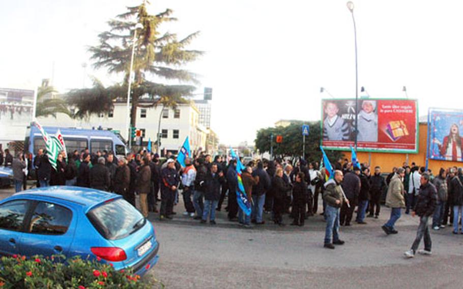 Roughly 100 Italian workers from the U.S. Navy base at Capodichino protested Wednesday morning and blocked vehicular access to the road that leads to the main gate of the base.