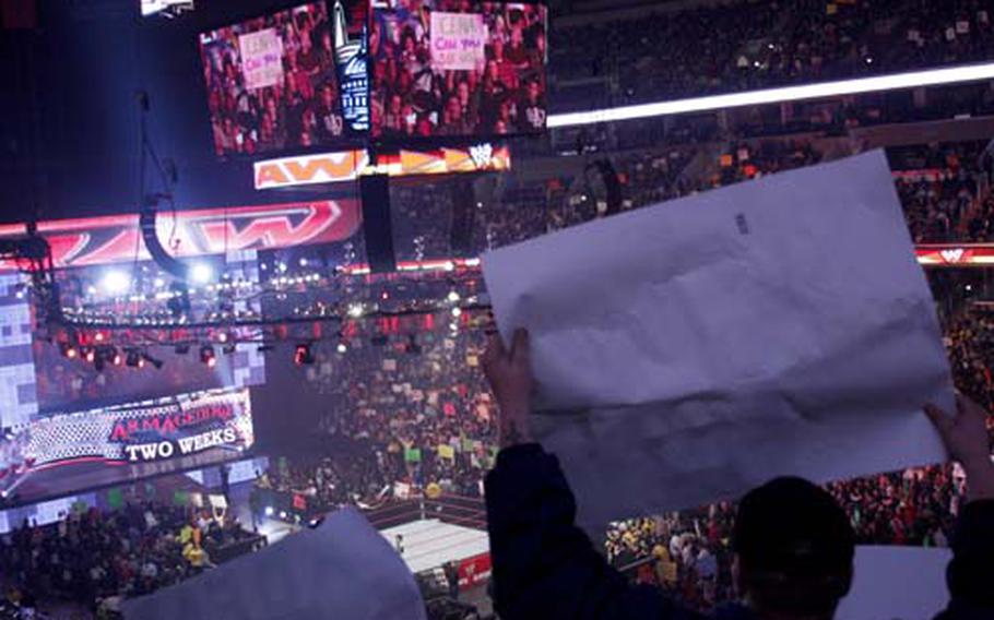 Fans wave signs during a commercial break.