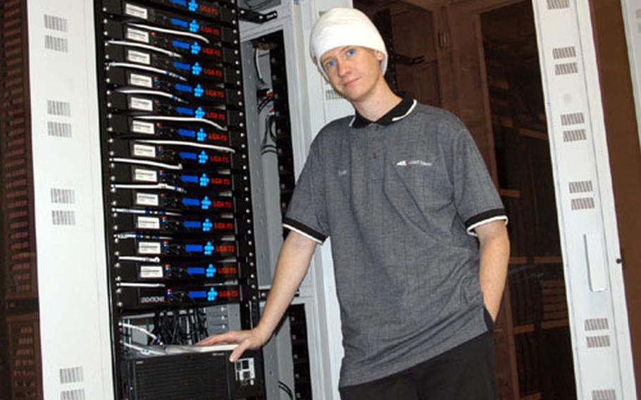 Tom Gann, an Allied Telesis network technician, works on installation of time-shift servers that will allow U.S. prime-time programming to be seen during evening hours at Yokota Air Base, Japan. The new service will be launched next week.