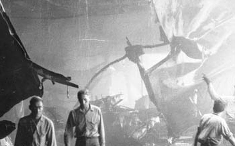 Crew members clean up wreckage and the dead after the crash.