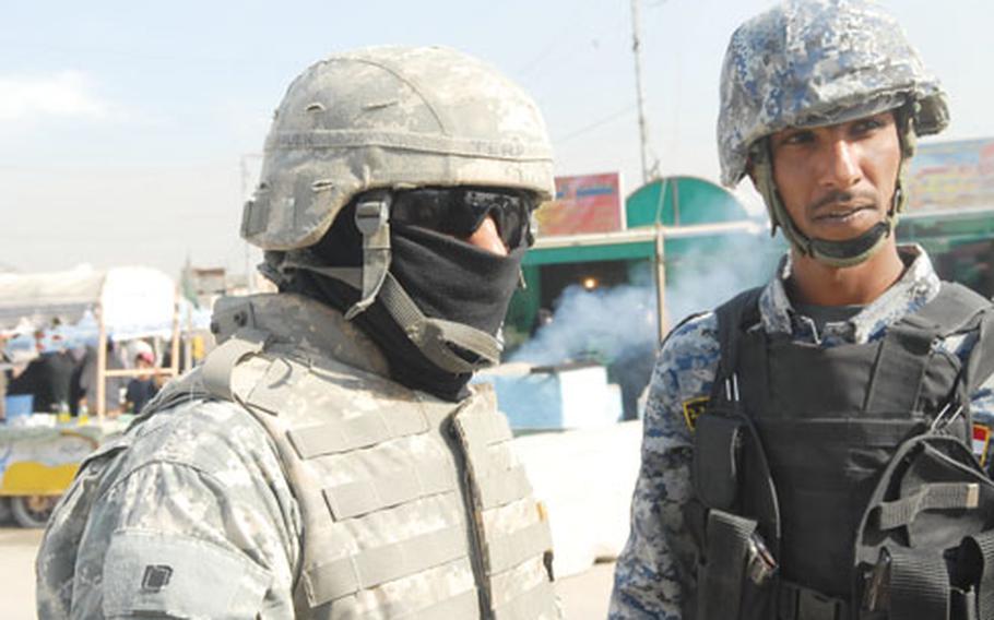 An Iraqi interpreter, left, translates a conversation between an Iraqi National Police officer and U.S. soldiers in Baghdad. American troops say interpreters’ English skills in Iraq have been uneven, leading to misunderstandings and hampering a mission that is shifting more to working with Iraqis on reconstruction efforts.