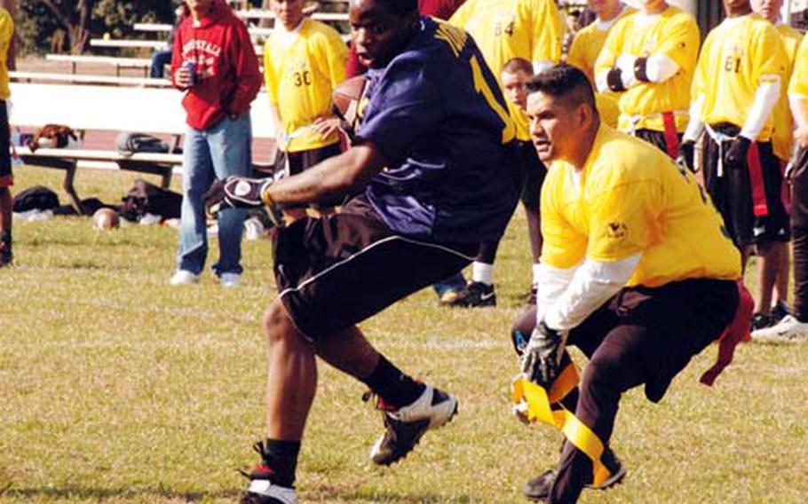 Yokosuka Naval Base&#39;s Lavoris Harris runs the ball for a last attempt at a goal during the final seconds of the game and downed just short of the goal by Army&#39;s David Gomez at an Army-Navy flag football game Saturday at Camp Zama, Japan. The Army team won 13-7.