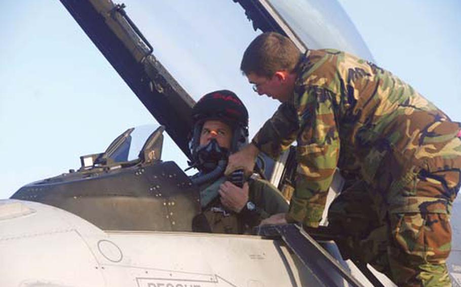 Senior Airman Matthew Horn, a 35th Aircraft Maintenance Squadron crew chief, assists Capt. Brian Sullivan, a 13th Fighter Squadron pilot, before launching their F-16 prior to a combat training sortie on Wednesday in the skies over Komatsu Air Base, Japan.
