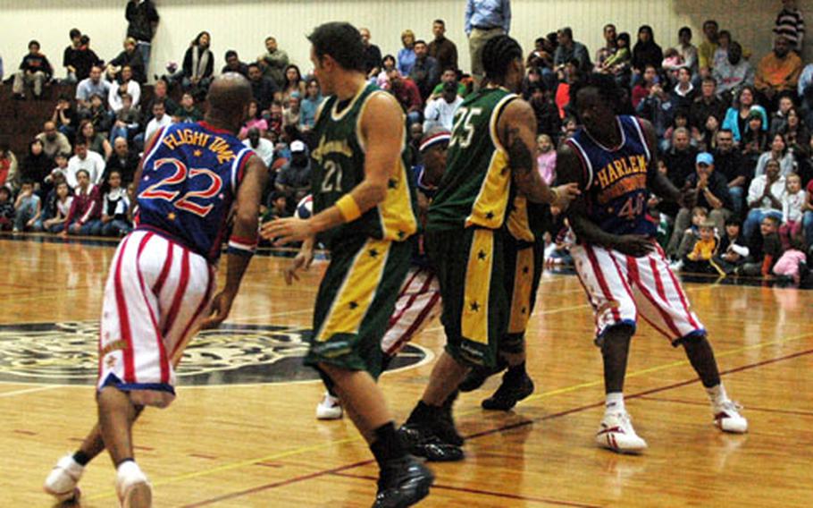 Harlem Globetrotters trap members of the Washington Generals in their trademark figure-eight offense during a game Friday night in the Samurai Fitness Center at Yokota Air Base, Japan. The Globetrotters visited Yokota as part of their holiday tour of military bases throughout the Pacific.