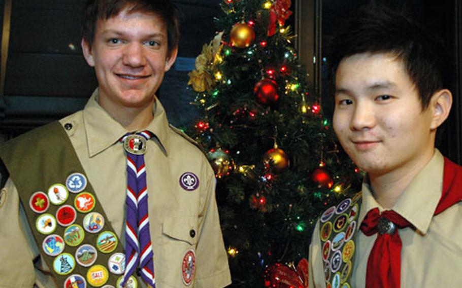 Michael Fogarasi, left, and Patrick Byun were honored Saturday night on Yongsan Garrison for becoming Eagle Scouts this year. To earn their ranks, Fogarasi helped with a renovation project at the base’s thrift store, and Byun led a blood drive at his church.