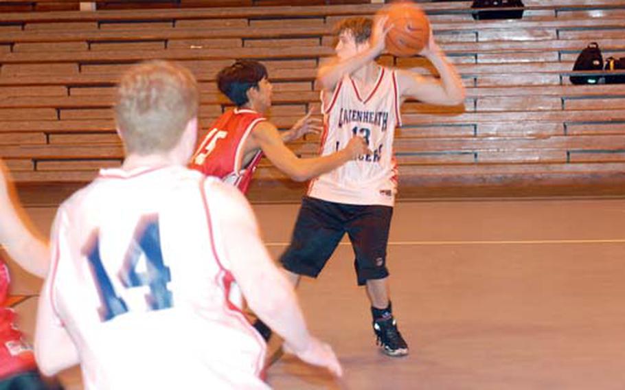 Lakenheath High School junior guard Zach Randolph watches as Mark DelaCruz guards Lancer boys’ basketball Team Captain Jeff Griffis. Players said the team’s chemistry and defense will be one of their strengths this season.
