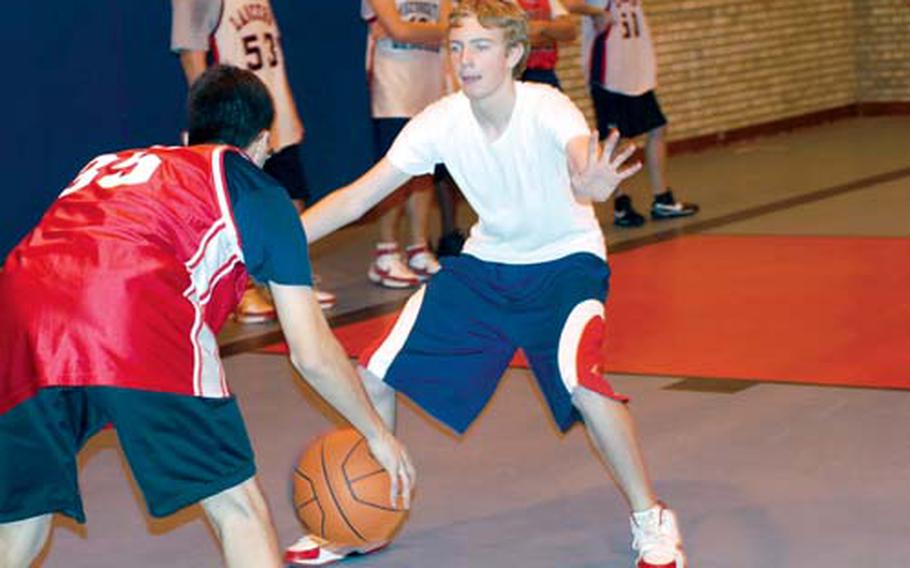 Lakenheath Lancer basketball player Brian Putt looks to drive the ball against Tyson Campbell during practice. The Lancers are coming off a 9-5 season and they are hoping to excel at the European championships this year.