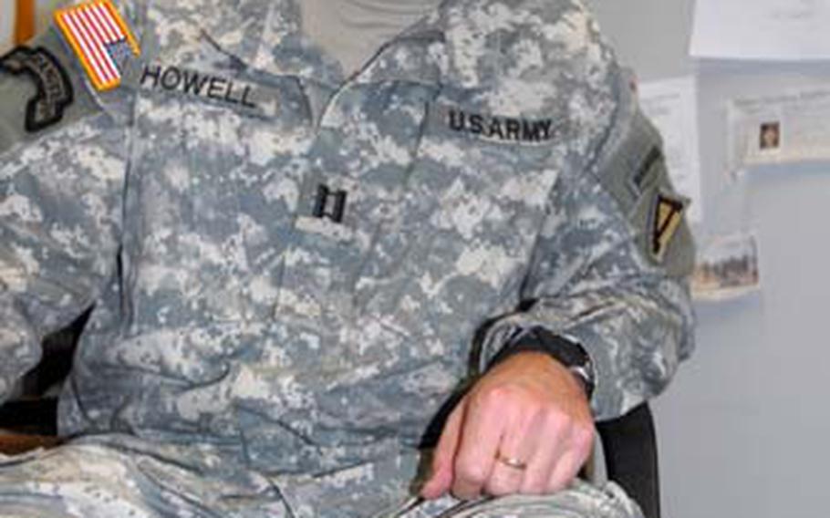 Team Cherokee commander Capt. Terry Howell shows the scars on his left knee, where he was wounded by enemy fire in Afghanistan.