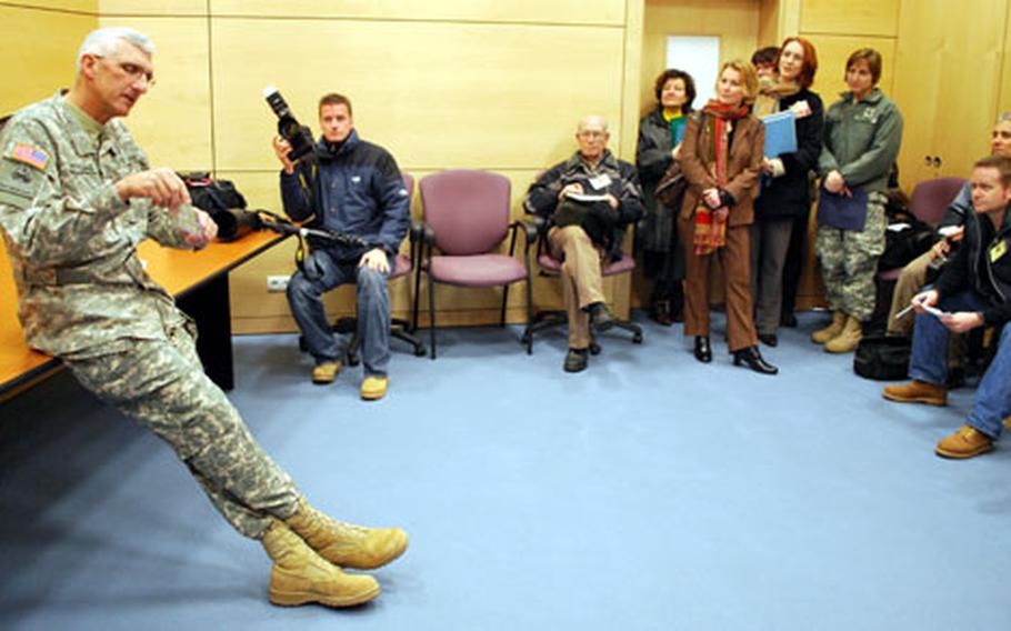 Maj. Gen. Mark P. Hertling shows reporters a flier for a candidate for governor of one of Iraq&#39;s northern provinces. It was one of the souvenirs from his 15 months in Iraq that he says shows the progress that was made.
