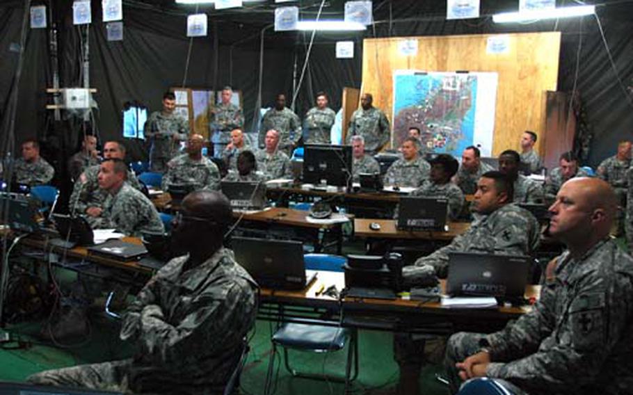 Members of the 8th Theater Support Command’s forward command post conduct a briefing on Friday during the Yama Sakura exercise at Camp Asaka, Japan.