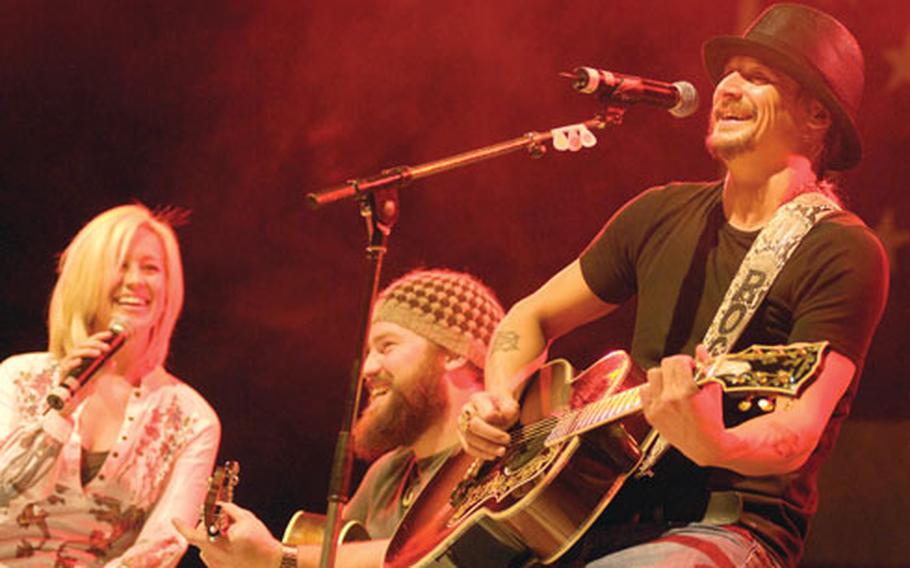 Kid Rock and Zac Brown smile through some botched lyrics during a song Tuesday.