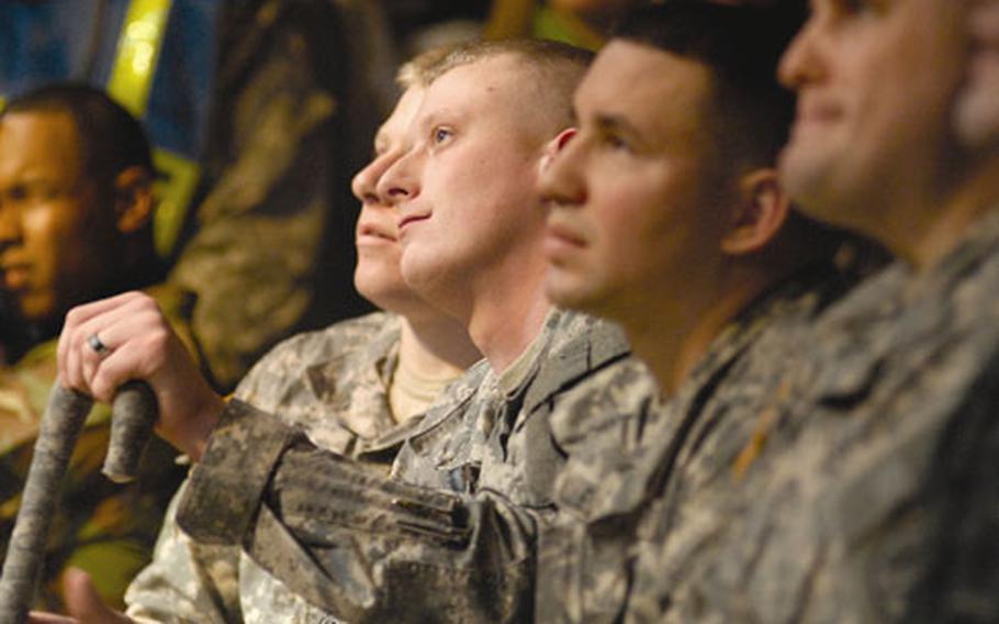 Army Spc. Kris Wynkoop takes in some of Kid Rock’s acoustic grooves during the show.