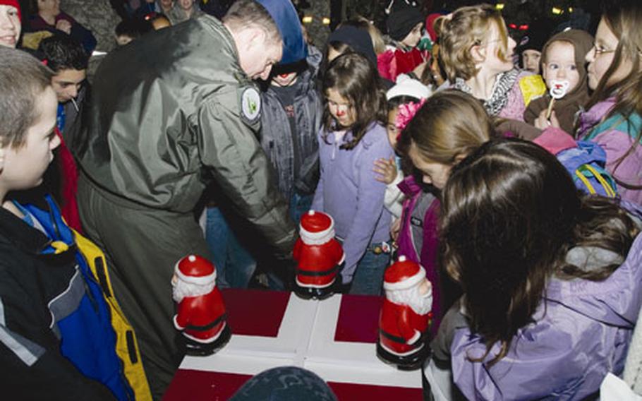 Col. Jay Silveria, commander of the 48th Fighter Wing, helps children turn on the Christmas tree during a lighting ceremony Dec. 5 at RAF Lakenheath.