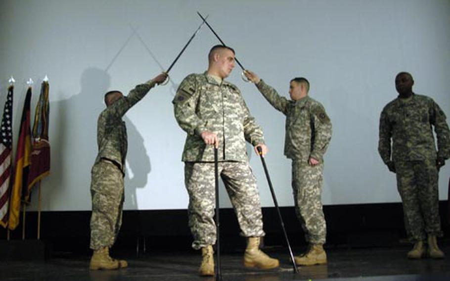 Army Sgt. Ryan J. Newell, a former member of Battery A, 5th Battalion, 7th Air Defense Artillery, lost both legs in an improvised bomb attack earlier this year in Afghanistan. He deployed soon after his promotion to sergeant, and had not been formally inducted into the noncommissioned officer corps. His former unit inducted him Wednesday.
