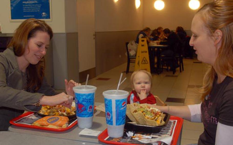 Grafenwöhr military spouses Haila Hill, left, and Jennifer Berlin share lunch with Jennifer&#39;s daughter, Makayla, 14 months, at the Grafenwöhr Post Exchange on Thursday.