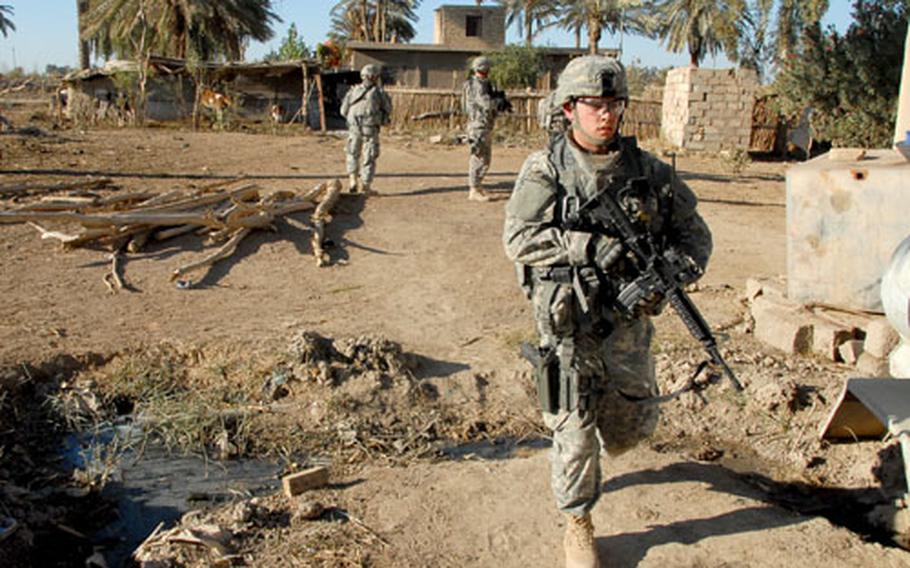 Second Lt. Kevin Mussman searches a farm where an al- Qaida operative was thought to be hiding Thursday. The wanted man is known for wearing a suicide vest and dressing like a woman to escape capture.