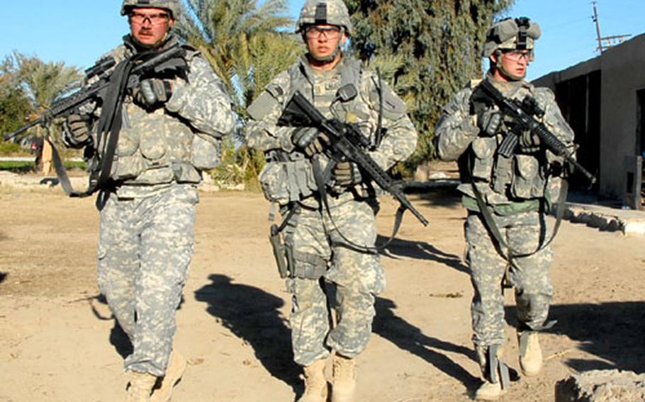 From left, Staff Sgt. Chad Kramer, 2nd Lt. Kevin Mussman and Pvt. Kenneth Eatinger search a farm where an al-Qaida suspect was thought to be hiding.