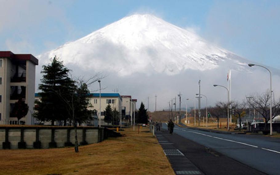 Clouds break to reveal Mt. Fuji, which overlooks the Combined Arms Training Center, Camp Fuji, Japan.