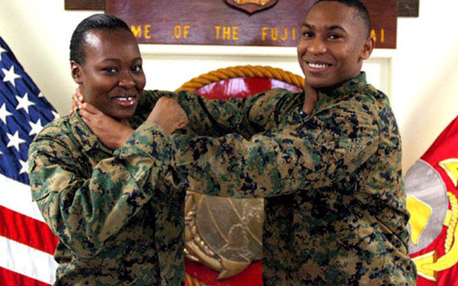 Showing a little sibling rivalry, from left, Lance Cpls. Zarina and Imran Ismail pose at the Camp Fuji headquarters. The sibling are among the 185 Marines assigned to the base.