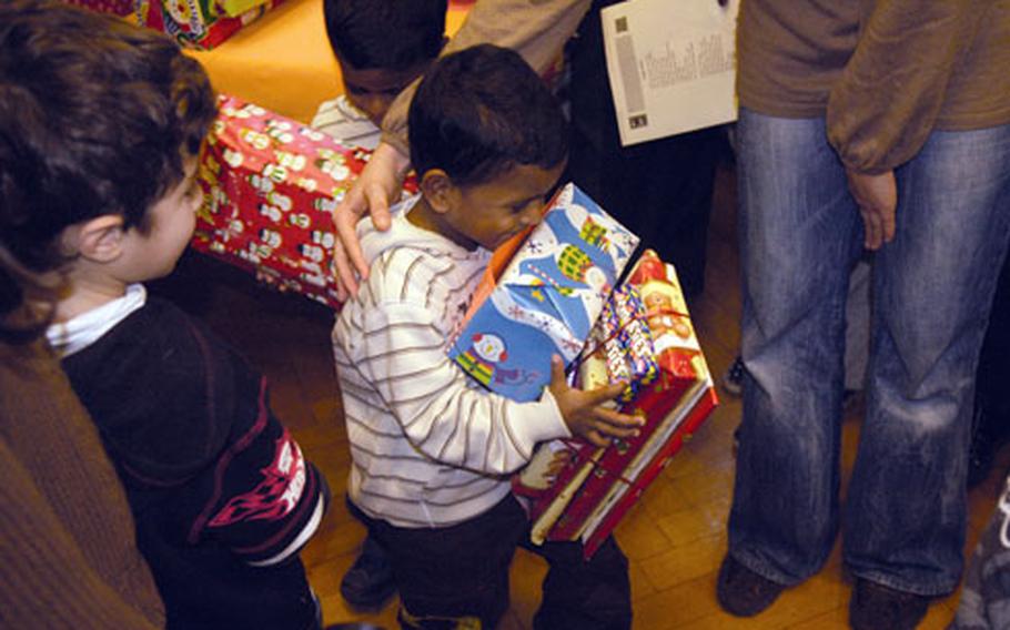 A youngster from Stuttgart struggles to carry all of his presents