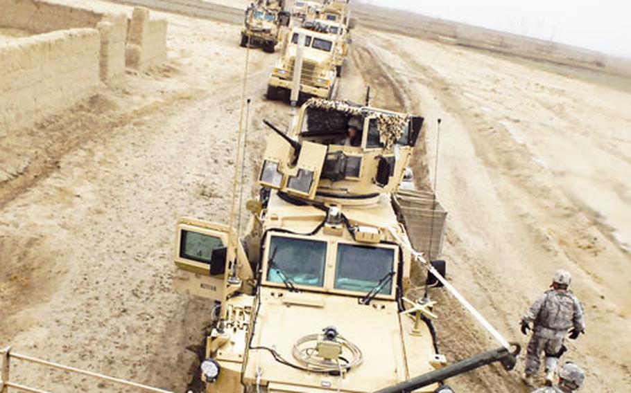 Route clearance vehicles lead a 60-vehicle supply convoy through the desert in Paktika province, Afghanistan. A sharp spike in roadside bombings this year has complicated the already difficult task of moving supplies across Afghanistan’s rugged terrain.