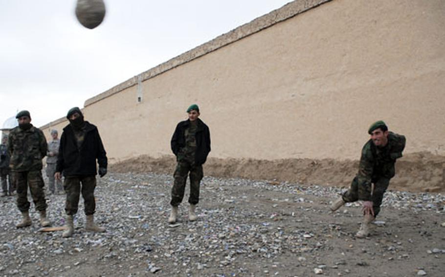 During a break in a three-day convoy that covered roughly 60 miles, Afghan soldiers participate in the proto-Olympic sport of "large rock tossing." The military relies on local trucking to move much of the fuel needed to run everything from generators and heaters to Humvees and armored vehicles.
