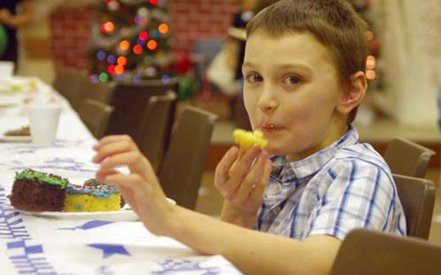 Jordan, an 8-year-old attending the event, enjoys some cake.