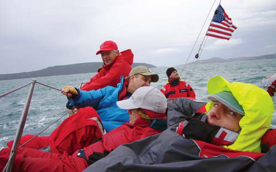 (From back to front) Navy Reservist Lt. Stuart Gold, Jan Chrypinski, Army Capt. Al Eckart, Navy Reservist Lt. Sandra Salvatori and Court Rawson gather on the high side of their vessel to keep it on keel during the Croatian Navy Cup and Christmas Regatta, a 28-nautical mile navigational run off the coast of Croatia.