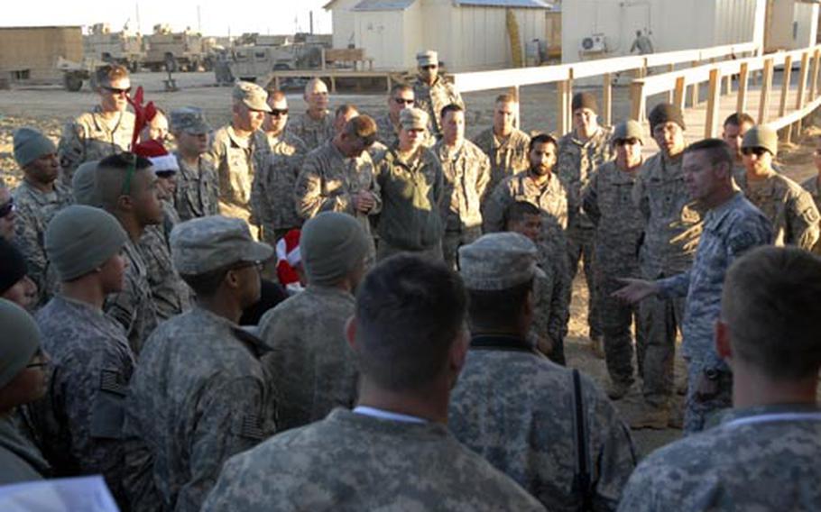 Maj. Gen. Jeffrey Schloesser, right, addressed troops at Combat Outpost Kushmand in southeastern Afghanistan on Christmas. Schloesser praised the troops&#39; work but warned them not to get complacent as their yearlong deployment begins to wind down.