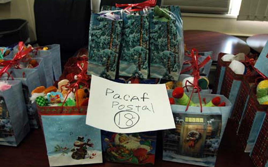 Project Elf gift bags destined for members of the Pacific Air Forces postal detachment who have to work through Christmas sit on a table Wednesday at Yokota Air Base's Yujo Community Center, awaiting pickup from unit leaders.