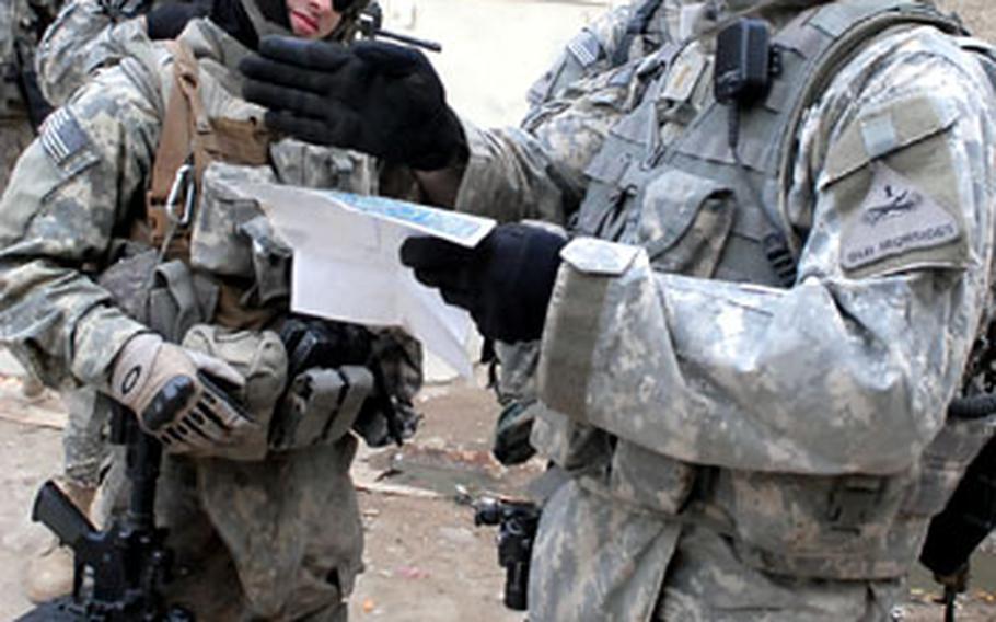 Soldiers with Company C, 1st Battalion, 35th Armor Regiment try to determine which of Sadr City’s many narrow streets they are on while searching for an address Monday. The platoon recently asked its Community Project Workers to map out the streets after learning that many residents didn’t even know the name of the street where they live.