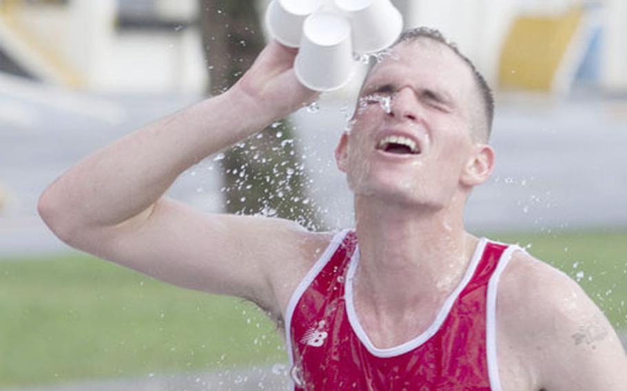 Cpl. Thomas Kunish cools off during the 18th Annual Camp Kinser Open Half Marathon Oct. 7. Kunish finished first overall with a time of 1:17:36, averaging less than six minutes per mile.