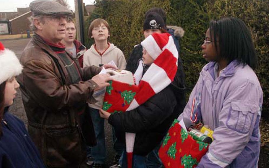 Science teacher Ted Berkey directs a group of Lakenheath Middle School students who made up this year’s Polar Express. The sixth-graders delivered canned goods and other household items to elderly residents of Feltwell.