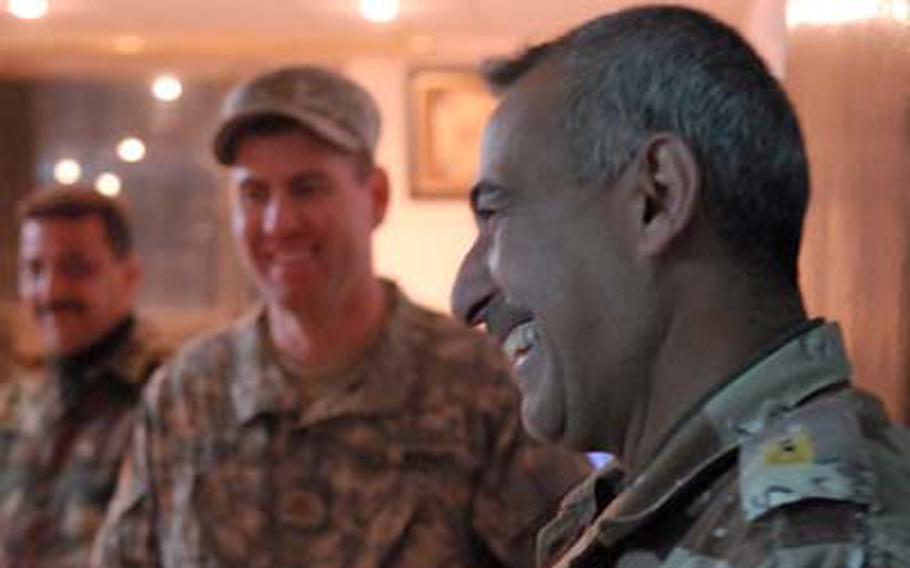 Maj. Hassoon Jaber, the 44th Iraqi Army Brigade operations officer, shares a joke with Maj. David Acker.