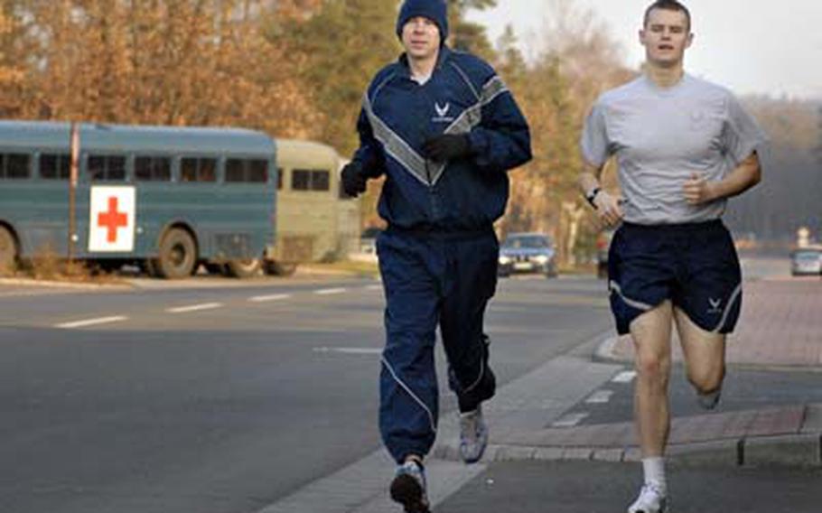 Tech. Sgt. Edward Pfeifer, left, and Airman 1st Class Ryan Abbey, both assigned to the 86th Aircraft Maintenance Squadron, go for an afternoon run Tuesday at Ramstein Air Base, Germany.