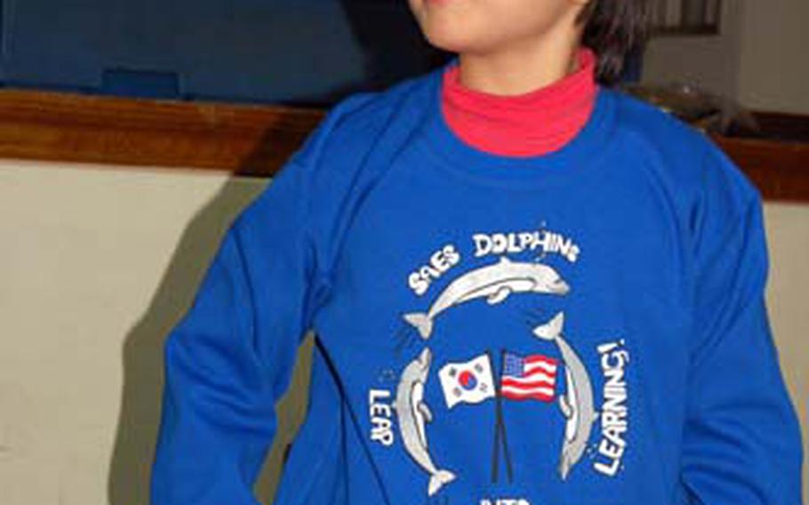 Alisa Nascimento, 9, sports a sweat shirt bearing a logo she designed. Alisa beat 75 other students in a competition to have their artwork displayed on the school’s “spirit wear.”