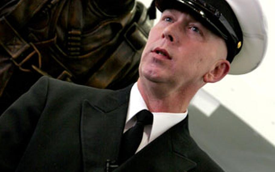 Command Master Chief J.D. Port said that with sea trials for the USS George H.W. Bush just a few weeks away, the thing he is most looking forward to is “The look on everyone’s face when they see what it’s like when a crew comes to life.” Here, Port stands in front of a scupture of the former president and ship's namesake as a naval aviator during World War II.