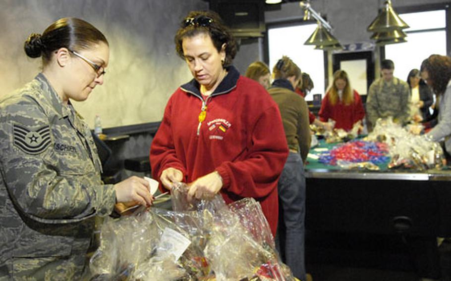 Tech Sgt. Elizabeth Tschoepe, left, an airman assigned to the 52nd Equipment Maintenance Squadron, and Teri Kendrick help other volunteers put the finishing touches on snack bags for troops heading to or returning from downrange Friday at Spangdahlem’s Club Eifel. Operation Open Arms has given away more than 24,000 bags and raised more than $10,000 in donations, according to Spangdahlem Red Cross station manager Tom Smith.