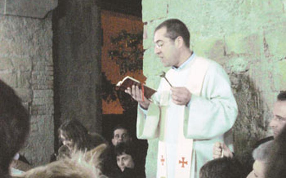 Father Pier Paolo Mantelli, priest at the Madonna del Carmine Catholic Church in Pozzuoli, a suburb of Naples, flicks holy water on the crowd of worshippers who gathered for the annual blessing of animals in observance of Feast Day of Saint Anthony of Egypt, a patron saint and protector of the lower animals.